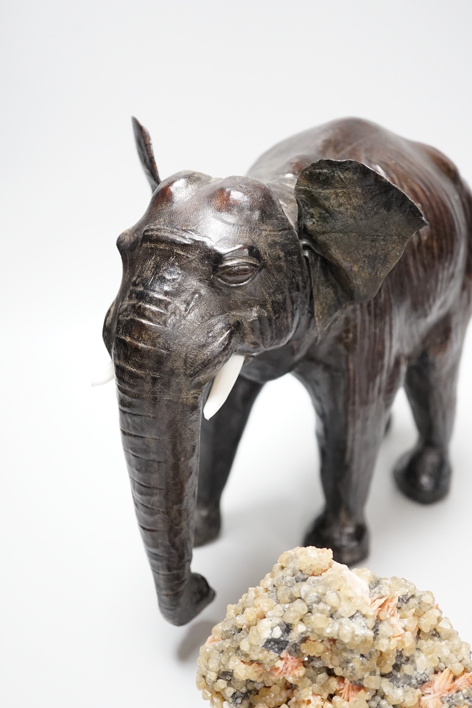 Two specimens; amethyst and rock crystal, and a leather model of an Indian elephant, 24cm high